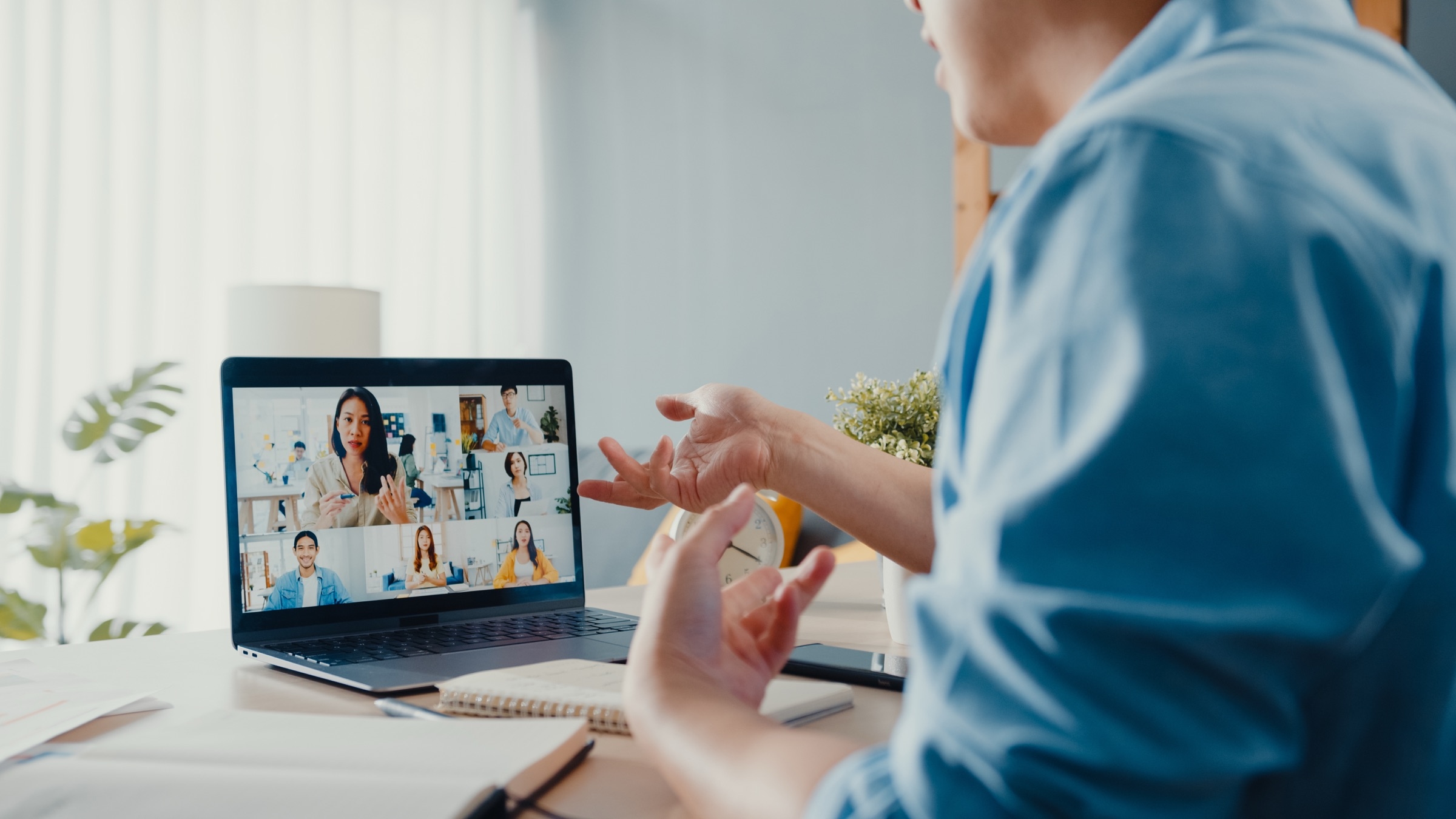 Man attending a virtual meeting with multiple participants