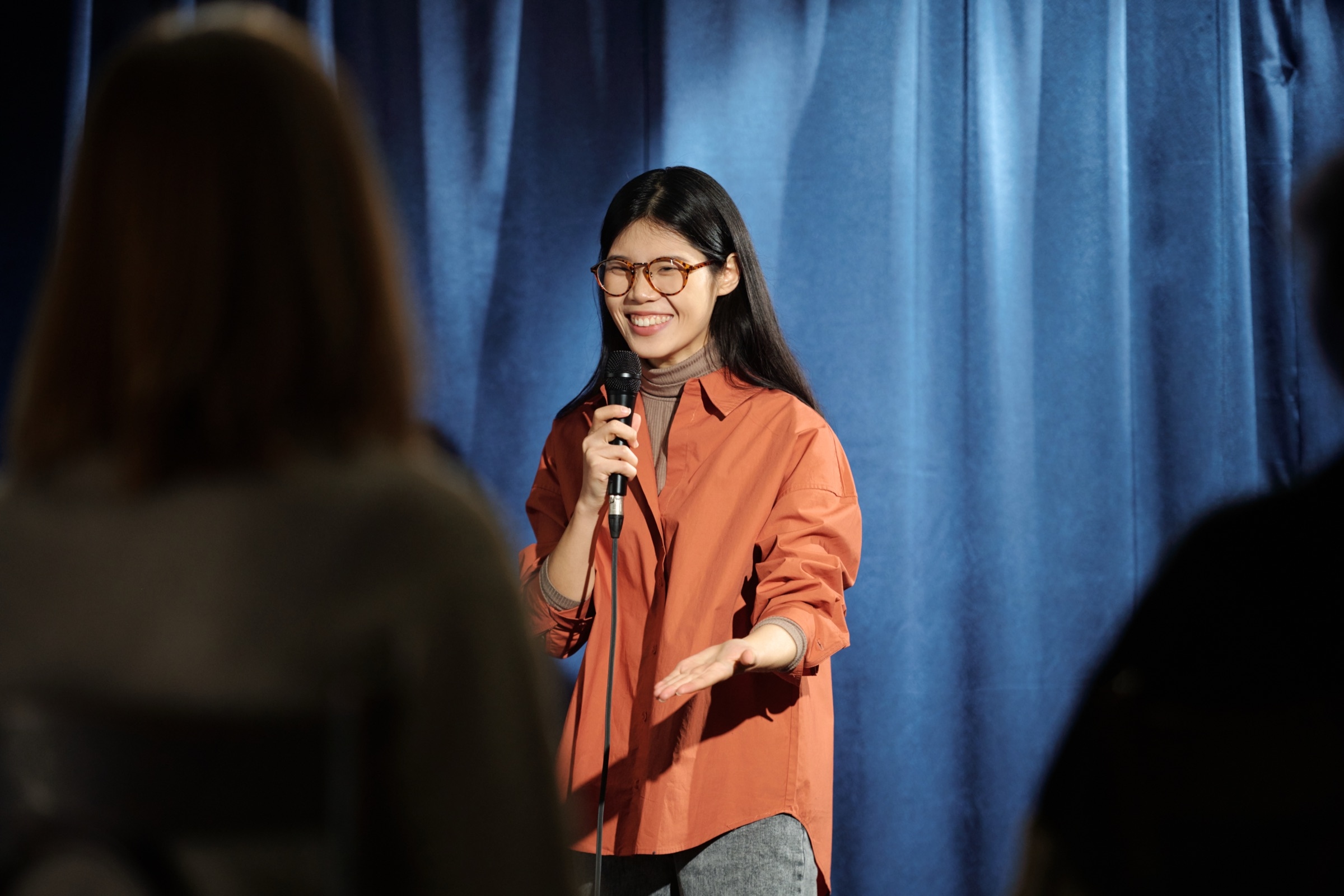 Smiling woman speaking into a microphone